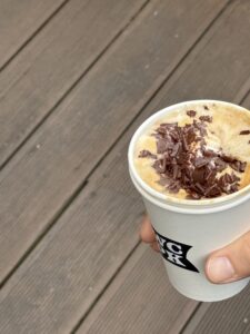 Warm cappuccino with sliced chocolate, East location