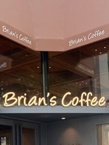 The iconic Brian's Coffee neon sign at the Posco intersection entrance