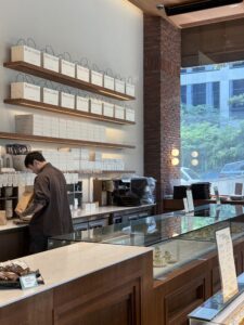 The pastry counter and retail shelf, with branded gift boxes stacked for takeout