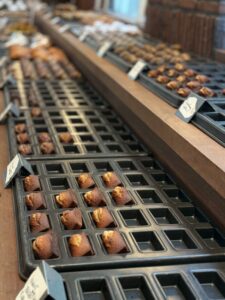 Freshly baked mini pastries laid out on the display counter, restocked throughout the day